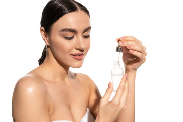 young woman with bare shoulders holding dropper with vitamin c serum isolated on white.