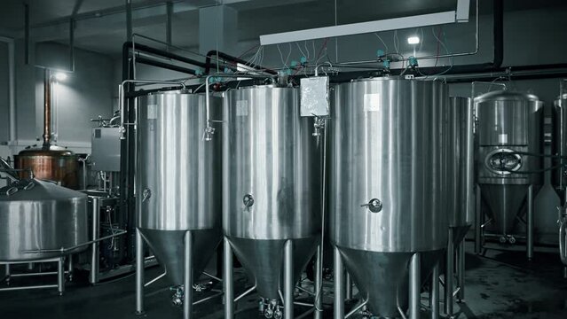 craft and traditional brewing, modern brewhouse in brewery with conical cylindrical fermenters