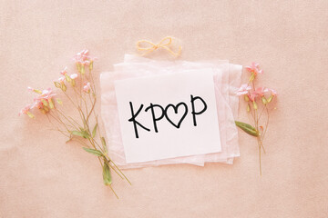 Kpop with heart - korean pop music concept, card with text and flowers on pink background