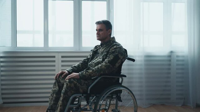 Portrait of serious military veteran with disability going through rough times
