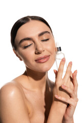 pleased young woman with natural makeup holding bottle with serum isolated on white.