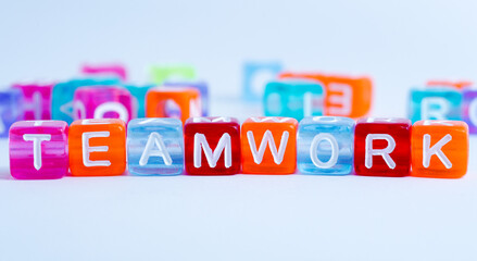 word "team work" on colorful cubes. fun concept about working together. inscription on the cubes. education sign series for education and learning