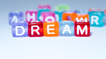 word "dream" on colorful cubes. fun concept of dream power. inscription on the cubes