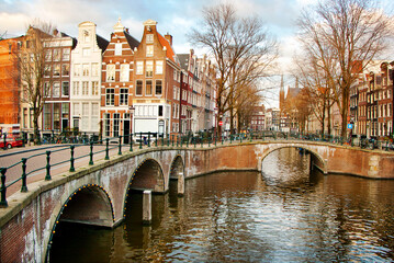 Old bridges and traditional houses along a canal in the centre of Amsterdam, the Nederlands