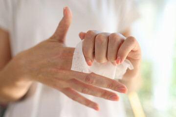 Female cleaning hands using antiseptic wet wipe, personal hygiene