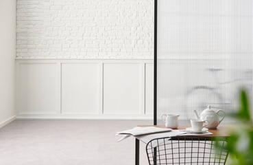 Close up desk and metal black chair, newspaper on the table, white classic and brick wall concept.