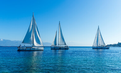 boats and yachts at the sailing regatta on open water. Sailing on the wind waves in the sea.