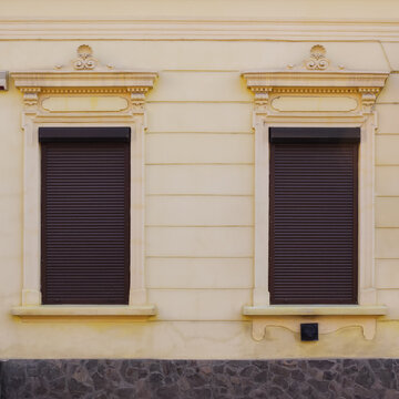 modern windows on the grunge facade. ancient architecture