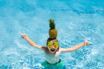 Child playing in the swimming pool. Summer kids activity. Little child playing in blue water.