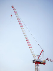 Silhouette of construction crane against cloudy sky. Housing construction, apartment block in city, restoration work in the city . Summer Travel to capital of Austria Vienna.