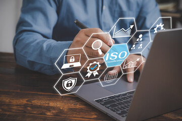 ISO standards quality control concept, assurance warranty. Businessman use a laptop to review and...