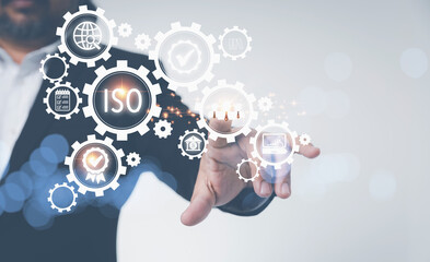 ISO virtual screen with business icons on gears. ISO Standard certification standardization quality control concept. Businessman touching people team icon with Certification and standardization.