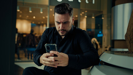 Upset anxious businessman 30s man having problem with mobile telephone read bad news unpleasant email on phone software error receive denial answer fail business deal disappointed male make mistake