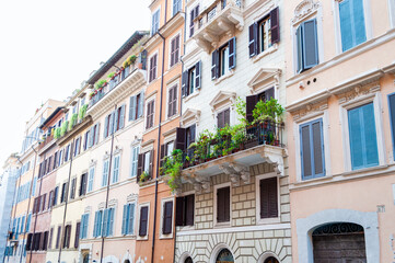 Fototapeta na wymiar Beautiful balcony with greenery on the facade of an old building in central Rome, Italy.