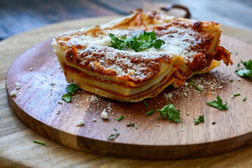   Delicious Home made  ketogenic Lasagna bolognese  with minced meat,tomato sauce and spinach  on a wooden rustic  background.Home made  keto diet italian meal