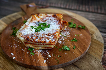  Delicious Home made  ketogenic Lasagna bolognese  with minced meat,tomato sauce and spinach  on a wooden rustic  background.Home made  keto diet italian meal