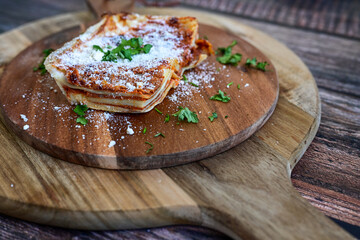   Delicious Home made  ketogenic Lasagna bolognese  with minced meat,tomato sauce and spinach  on a wooden rustic  background.Home made  keto diet italian meal
