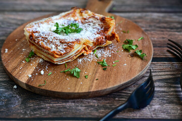   Delicious Home made  ketogenic Lasagna bolognese  with minced meat,tomato sauce and spinach  on a wooden rustic  background.Home made  keto diet italian meal