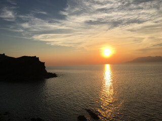 Sunset, waves and volcanic mountain view from Yildizkoy beach on Gokceada Imbros island. Canakkale Turkey
