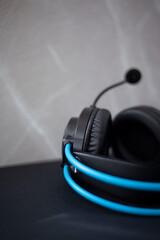 Black headphones with blue tubes that go around the head, headphones with a microphone