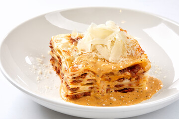 lasagna with sauce on the white plate