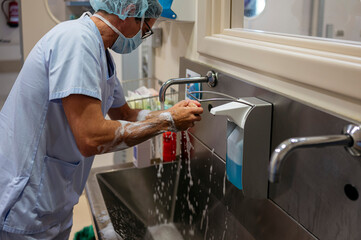 doctor washing his hands in the operating room.