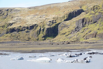 Chunks of ice floating in lake at Solheimajokull glacier in Iceland