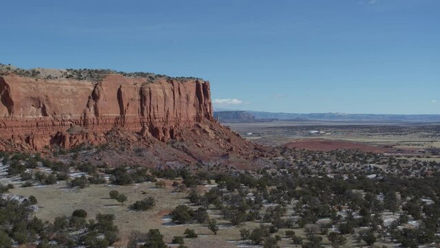 Aerial of New Mexico red rock landscape with sandstone mesa in winter