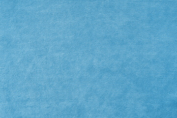 Texture background of velours light blue fabric. Upholstery velveteen texture fabric, corduroy...