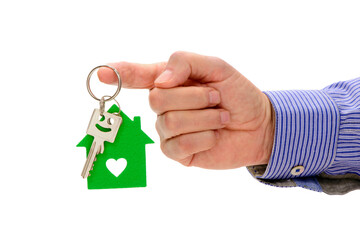 isolated house key holding in hand