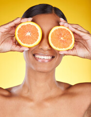 Skincare, beauty and portrait of Indian woman with orange and facial detox with smile on yellow background. Health, wellness and model face with organic luxurycleaning and grooming cosmetics.