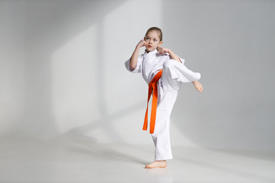 Kicking stand, karate child on a white background.
