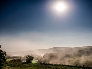 Moon light shinning through the fog covered valley