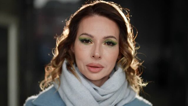 sexy lady looking at camera, closeup portrait of attractive middle-aged woman in coat and scarf