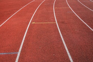 red runway with change markings for a relay race