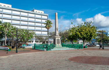 Downtown square with brick walkway and palm tree and historic marker in Bridgetown, Barbados. ...