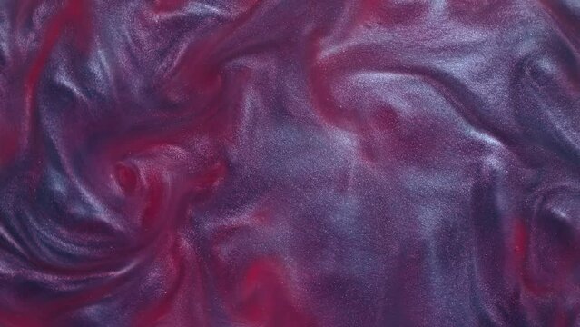 Liquid violet purple motion organic background. Shine glitter fluid metallic color paint. Texture abstract acrylic cloud swirling underwater.