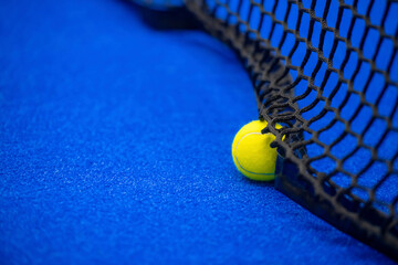 Yellow tennis and padel ball in court on blue turf. Horizontal sport poster, greeting cards, headers, website