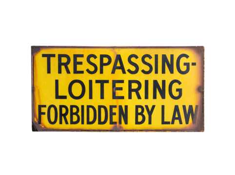 Rusty old trespassing and loitering forbidden by law sign.  Isolated with cut out background.