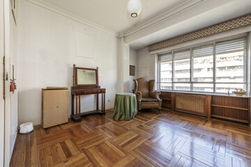 Vintage-style living room with beautiful hardwood floors, loose furniture and a large aluminum and glass window