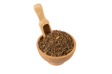 Valerian herb root in wooden bowl and scoop isolated on white background. Valeriana officinalis. used in herbal medicine as a tranquillizer and to treat insomnia, anxiety, hypertension, pain relief.