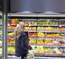 Woman buying fruits and vegetables at the market