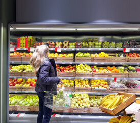 Woman buying fruits and vegetables at the market