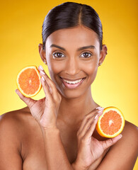 Skincare, smile and portrait of Indian woman with orange and facial detox with smile on yellow background. Health, wellness and face of model with organic luxurycleaning and grooming cosmetics