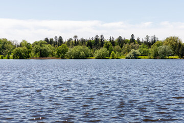 Panoramic view of lake surrounded by forest. Natural landscape.