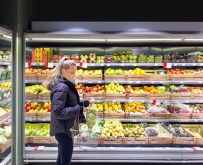 Woman buying fruits and vegetables at the market