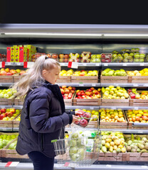 Woman buying fruits and vegetables at the market