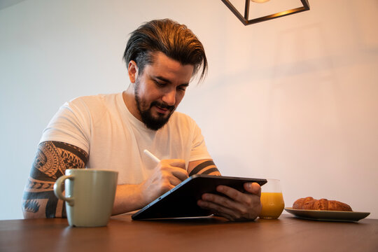 Handsome young man drawing something on a tablet