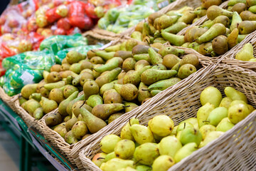 Shelves with natural fruits pears in supermarket or farmer market. Fresh food. Selective focus