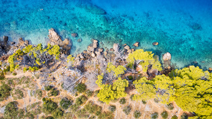 The stunning beauty of Croatia's rocks and forests is captured in this breathtaking aerial view. Take in the turquoise waters and beach from above, and add this travel image to your collection of unfo